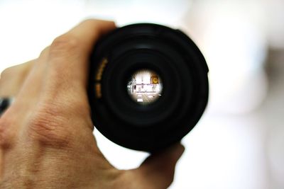 Cropped image of person holding camera