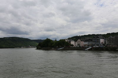 View of town by sea against sky