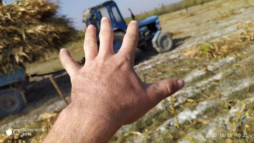 Close-up of man hand gesturing at farm