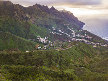 Scenic view of sea and mountains against sky