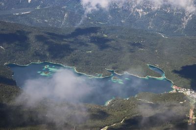 High angle view of lake eibsee between clouds 