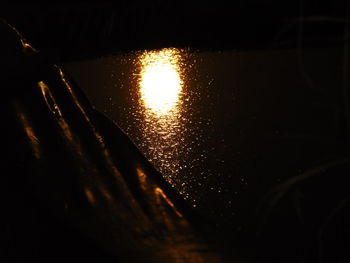 Close-up of illuminated water against sky at night