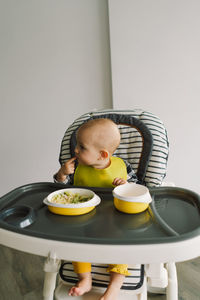 Little child with solid nutrition. baby girl eating food and mix vegetable plate