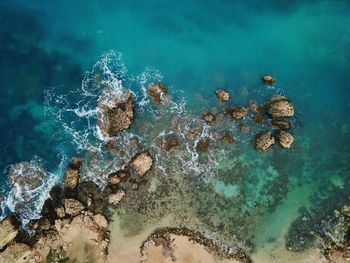 Aerial view of rocks in sea