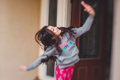 Full length of woman standing at home