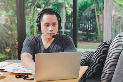 Young woman using laptop at home