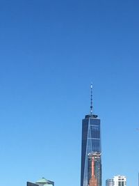 Low angle view of skyscraper against clear blue sky