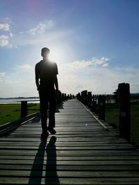 Rear view of a man walking on road