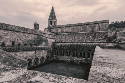 View of old building against cloudy sky