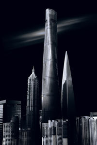 Low angle view of modern building against sky at night