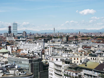 Aerial view of cityscape against sky during sunny day