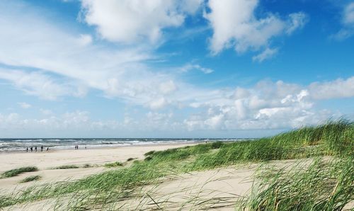 View of beach against cloudy sky