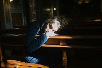 Portrait of woman sitting on table