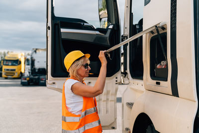 Side view of woman standing near truck