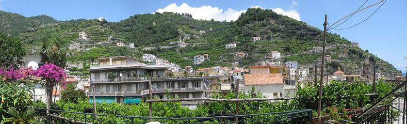 Houses on mountain against sky