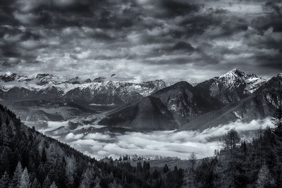 Scenic view of snowcapped mountains against dramatic sky