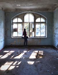 Full length of woman standing on railing