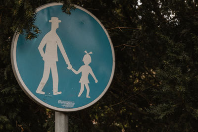 Close-up of road sign against trees