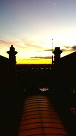 Silhouette built structures at sunset