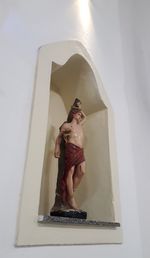 Low angle view of statue against wall