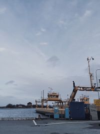 View of harbor against cloudy sky