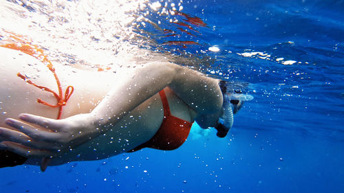 Close-up of young woman swimming in pool