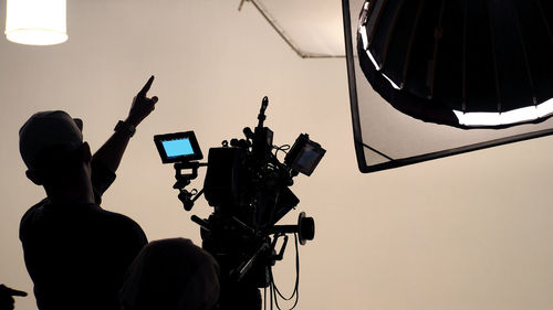 Silhouette man photographing working