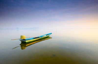 Boat in lake against sky