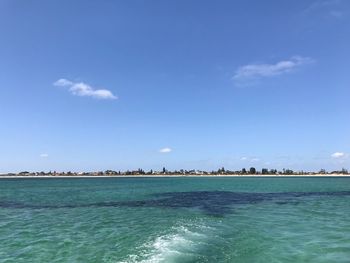 Scenic view of sea against blue sky