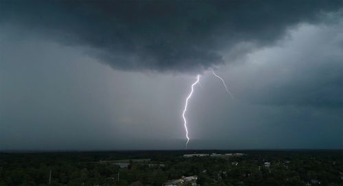 Lightning over cityscape against storm clouds