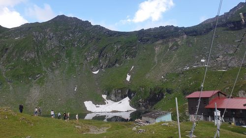 Scenic view of field and mountains against sky