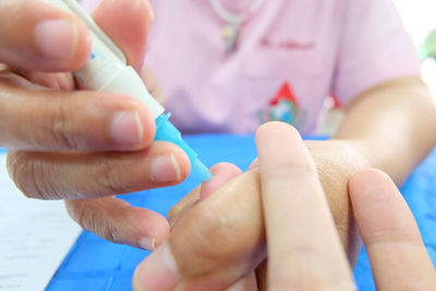 Midsection of doctor injecting patient in hospital