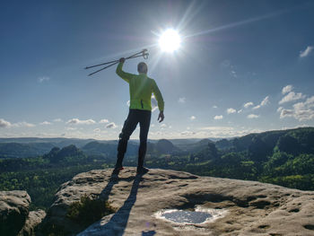 Man standing on mountain against sky