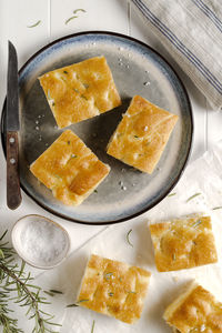 Italian focaccia on white wooden table. top view.