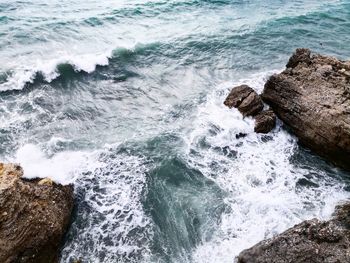 High angle view of rocks in sea