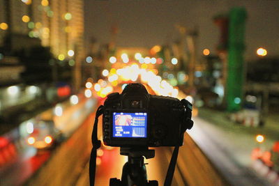 Illuminated city street seen through camera