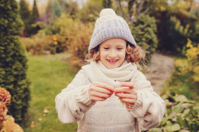 Portrait of a smiling young woman in park during winter