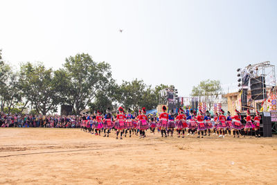 Group of people against plants against clear sky