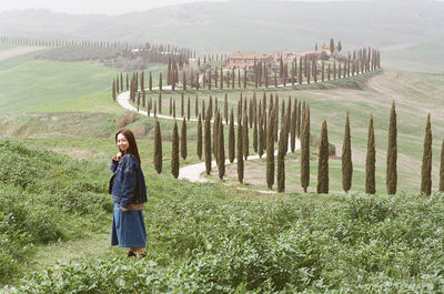 Rear view of woman standing on field