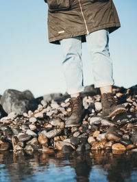 Low section of man standing on rock