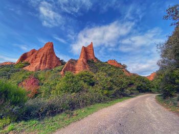 Road by mountain against sky