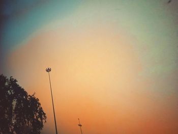 Low angle view of silhouette street light against clear sky