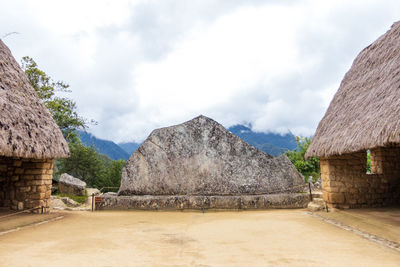 Scenic view of mountains and houses against sky