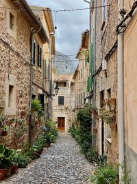 Narrow alley amidst old buildings in city