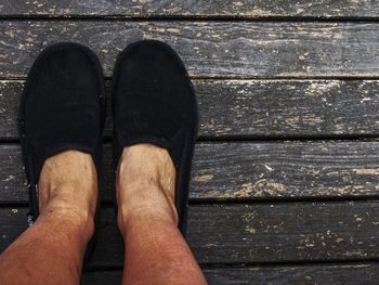 Low section of man on boardwalk