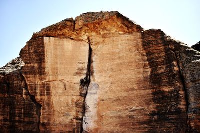 Low angle view of rock formation against sky
