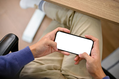 Midsection of woman using digital tablet at home