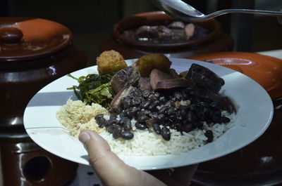 Close-up of cropped hand holding food