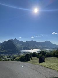 Scenic view of mountains against sky on sunny day