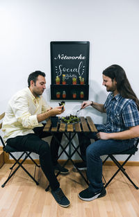 Two men sharing a healthy meal at the office